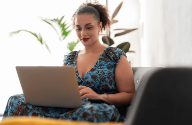 A woman smiles when she sees the Happy Healthy You promo code on his computer