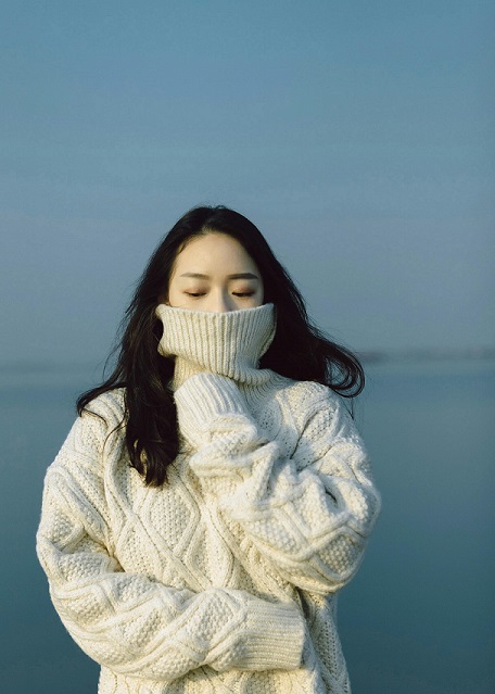 Image showing a woman wearing an example of the good quality COS knitwear