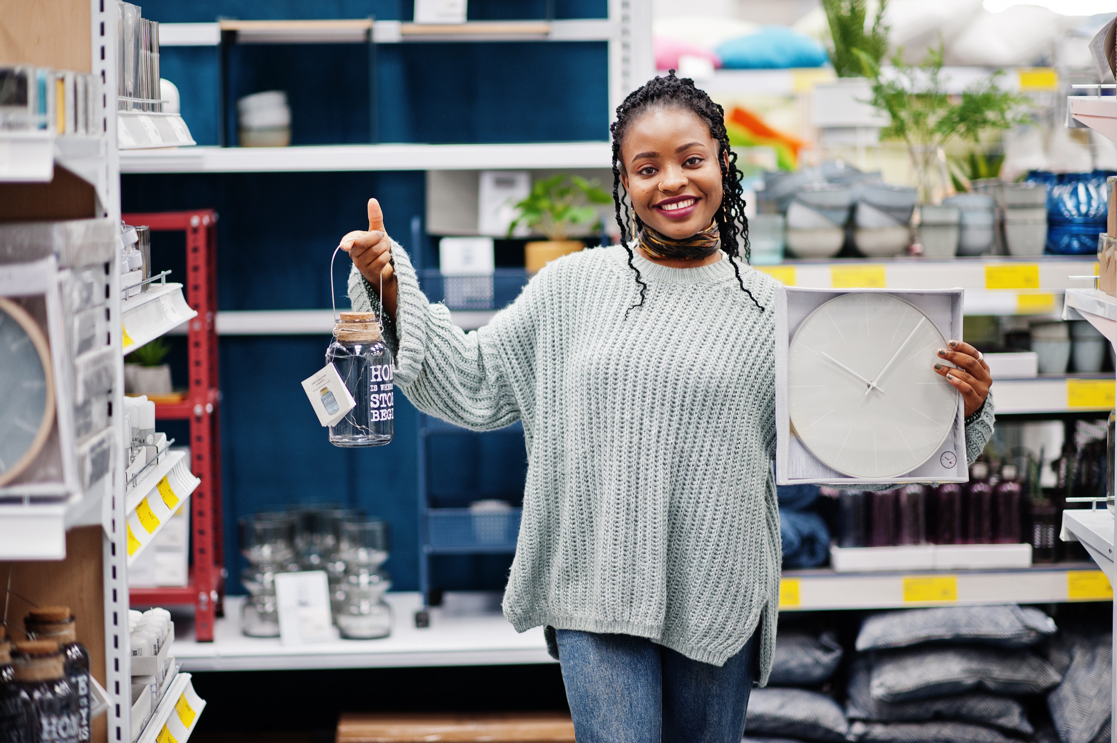 african-woman-choosing-clock-her-apartment-modern-home-furnishings-store