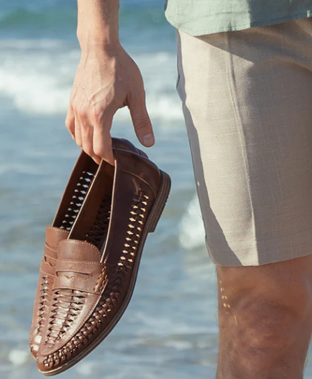 A gentleman holding brown loafers from House of Cavani