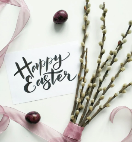 A Happy Easter card and white petal flowers with a pink ribbon
