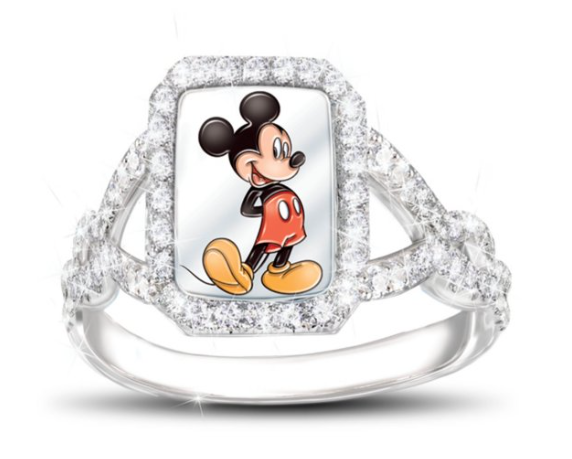 A picture of a diamond ring with an oval shape with a picture of Mickey Mouse in the middle of the ring