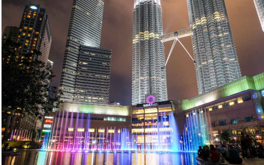 Tourists watching and indulging in colourfully lit high rise buildings in Kuala Lumpur