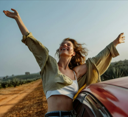 A woman wearing a white crop top while on a road trip