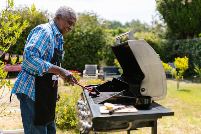 Things to do during the summer: A man cleaning the barbeque stand