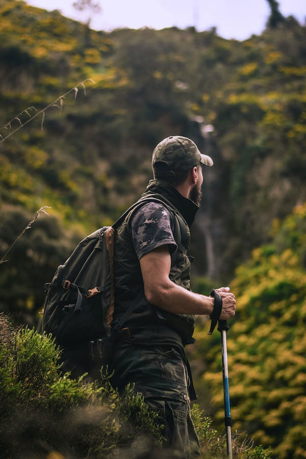 A hiker who has a chronic condition with their leg hiking in the mountains