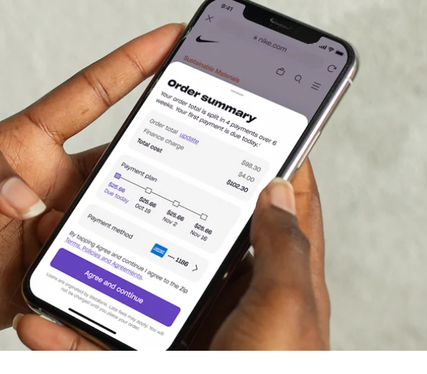 Hands holding mobile phone with the Zip app being used
