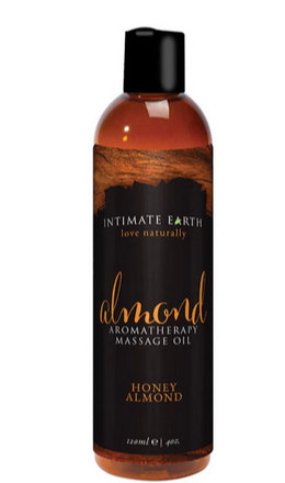 Almond Aromatherapy Massage Oil is written on the sticker of an oil bottle with a black lid, and its contents brown.