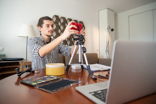 A man fimling a video using Elgato's products he saved on with an Elgato coupon code
