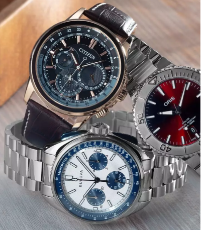 Three different types of luxury watches stacked on a flat surface