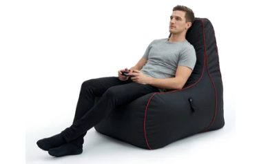 A man sitting on a Game Over beanbag chair
