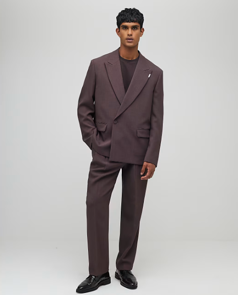 Wedding guest suits: A model wearing a relaxed-fit pleated suit set
