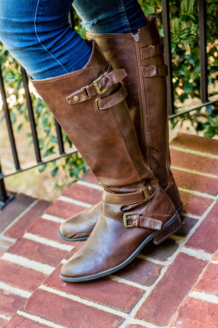 Brown leather knee-length boots with buckles.