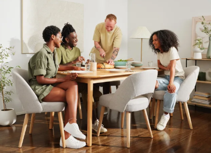 Friends are sitting at the table talking about Koala deals