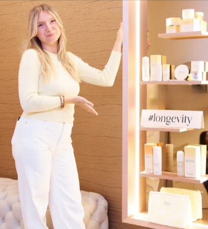 A woman showing her collection of IRÄYE skincare that she saved on with an IRÄYE voucher code