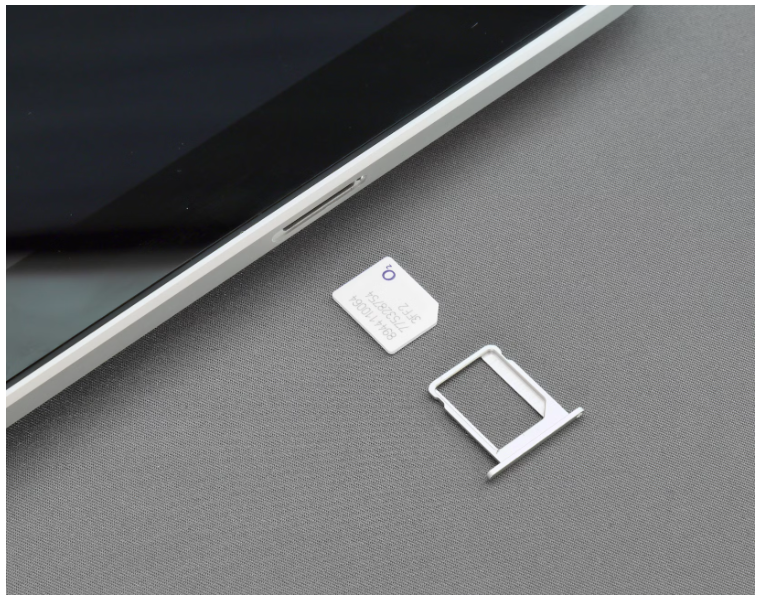 A sim card beinf placed in a phone