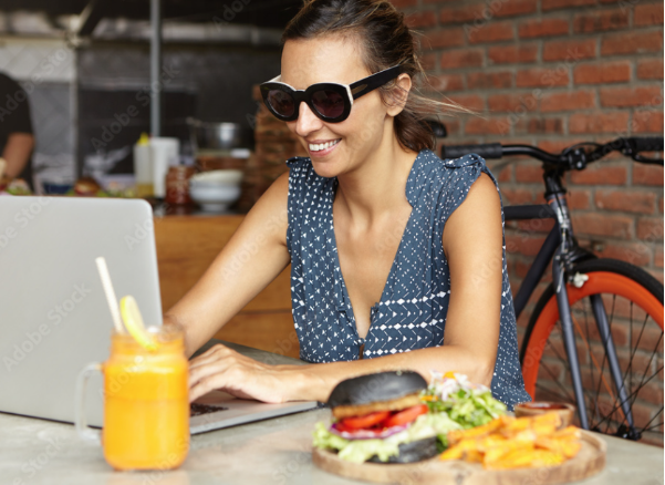 during lunch, a student looking at her computer for Youfoodz promo code