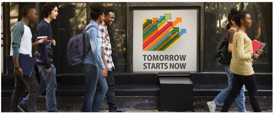 A group of students walking to a Fila discount sale as they excitedly discuss their favourites that they will be buying from the new merchandise advertised
