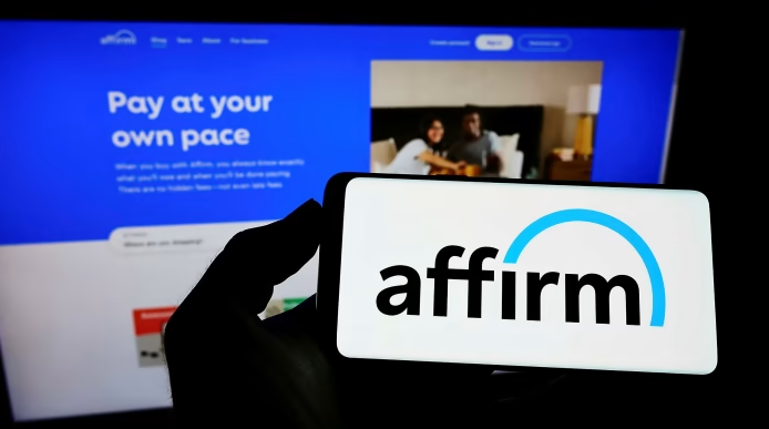 A hand holding a smartphone with the Affirm logo showing on the screen