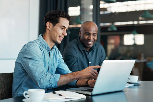 Two men looking at a Step One promo code on a laptop.
