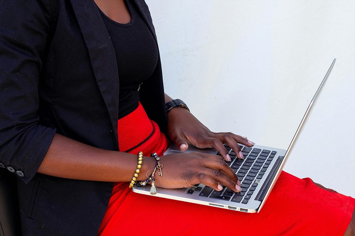 Image showing a woman's hands typing on a laptop.