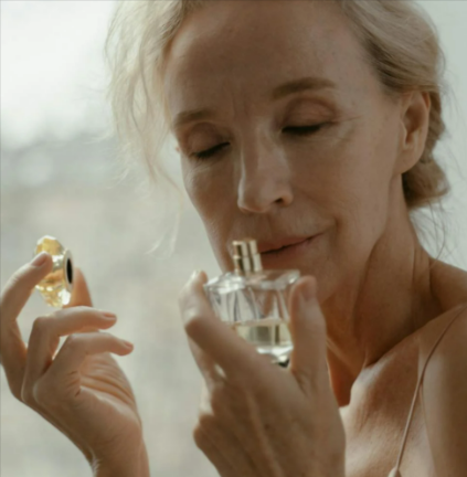 An elderly woman smelling a fragrant perfume from CreationWatches