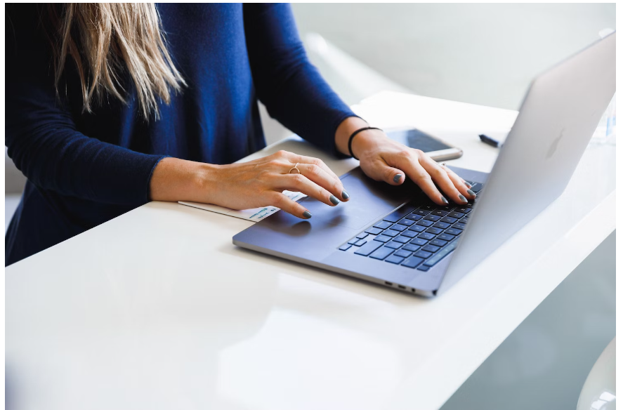 A female student scrolling through her laptop for a The Future Rocks promo code to purchase jewellery pieces