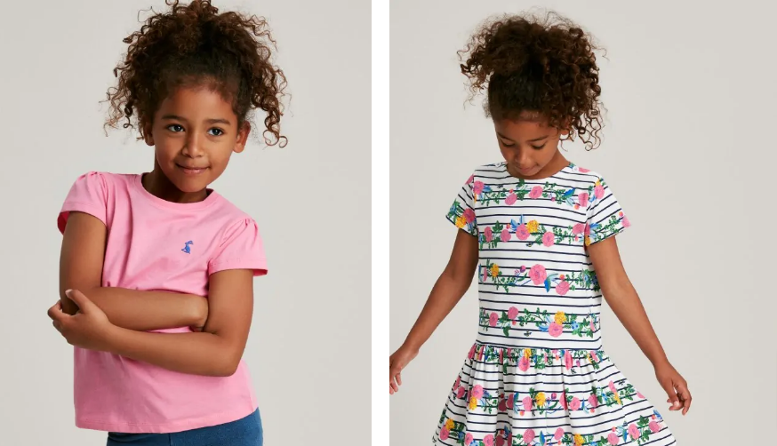 Girls wearing clothes from the Joules kids clothing section, a floral dress and the other a pink top