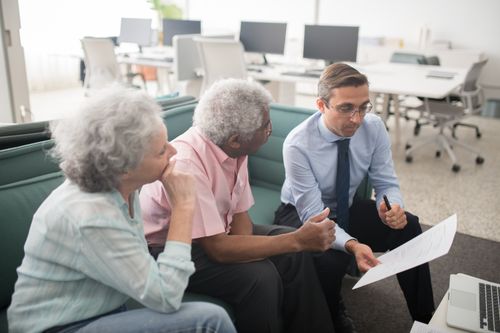 An elderly couple opeing an retirement account with a Hargreaves Lansdown consultant