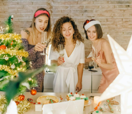Three-Women-Holding-Glasses-Of-Wine-While-On-Video-Call-