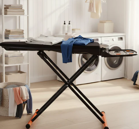 A Foxydry Vivo in a laundry room with white washing machines and clothes