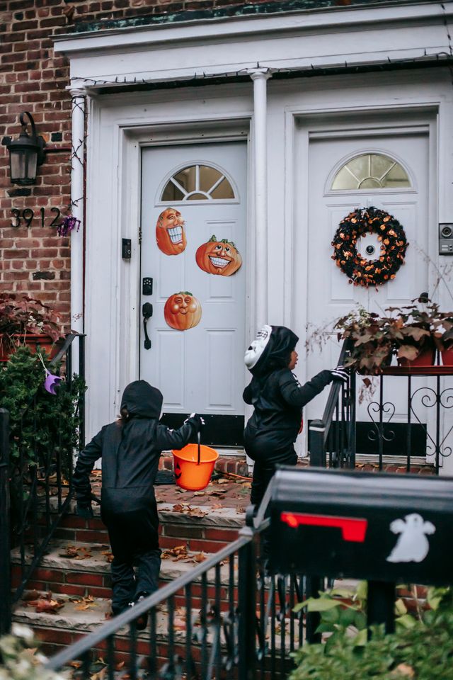 Two children going trick-or-treating during Halloween
