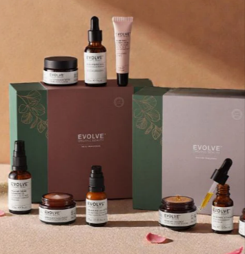 A display of different Evolve Beauty products including their gift set and lip therapy