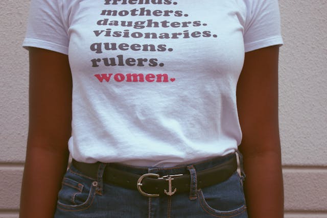 A woman wearing a shirt with wording on it