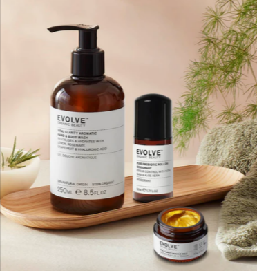 The Evolve Beauty body wash, deodorant and body scrub in a neutral tone bathroom