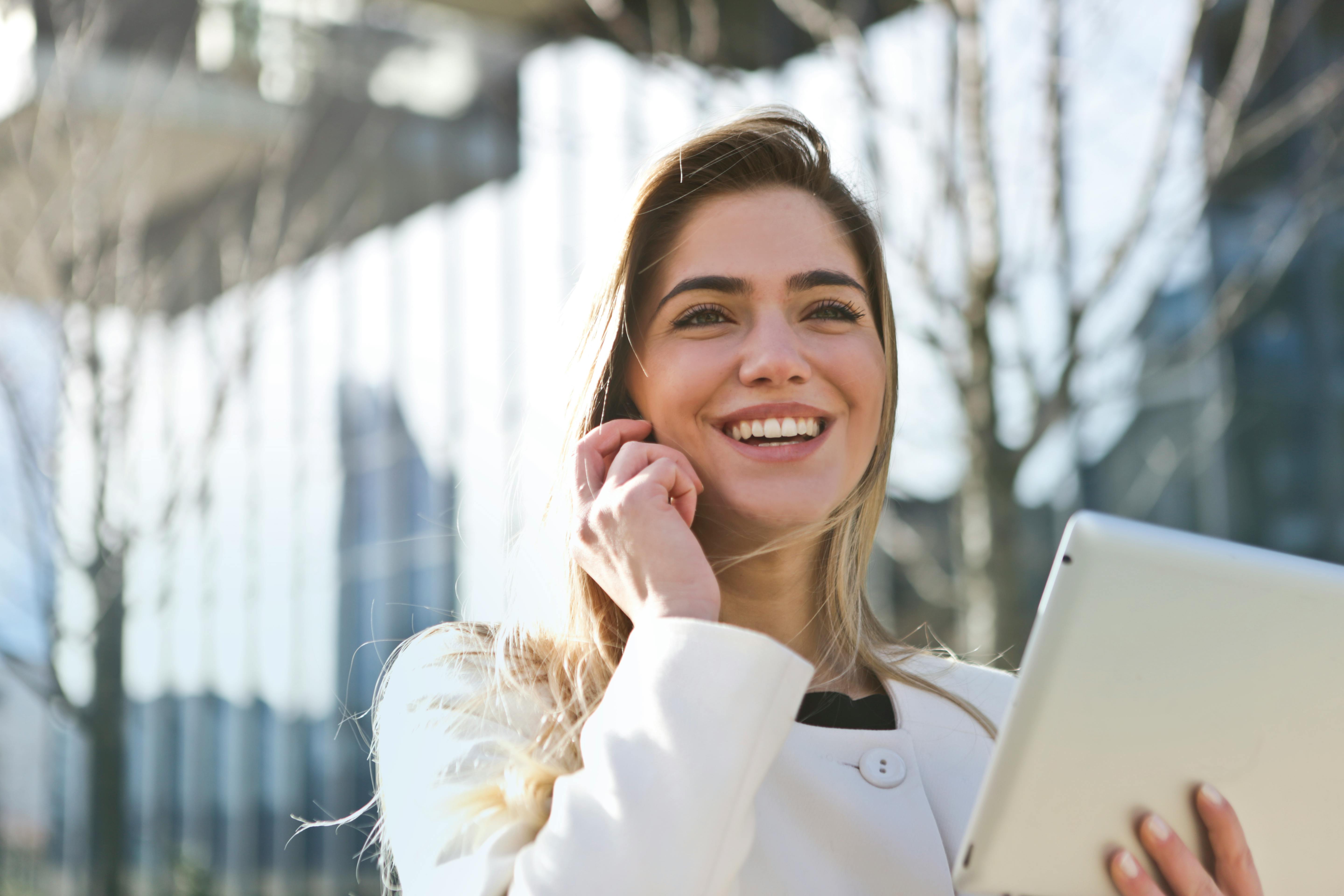 A lady using her phone and laptop