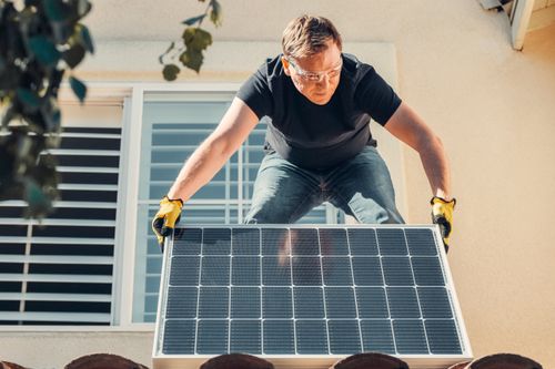 A technician installed a solar panel that someone saved on with a Heatable discount code