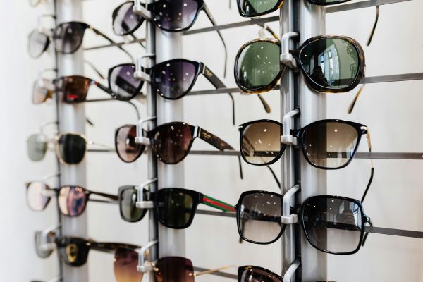 A display rack with multiple pairs of designer sunglasses in different colours and styles