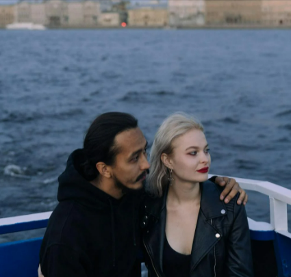 A couple wearing black on a cruise booked using a last-minute deal