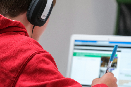 young Uk boy working on his school project on the laptop
