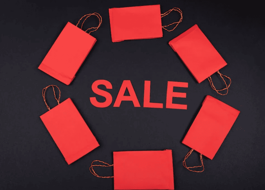paper bags on a black background with the word 'sale' in all capital letters