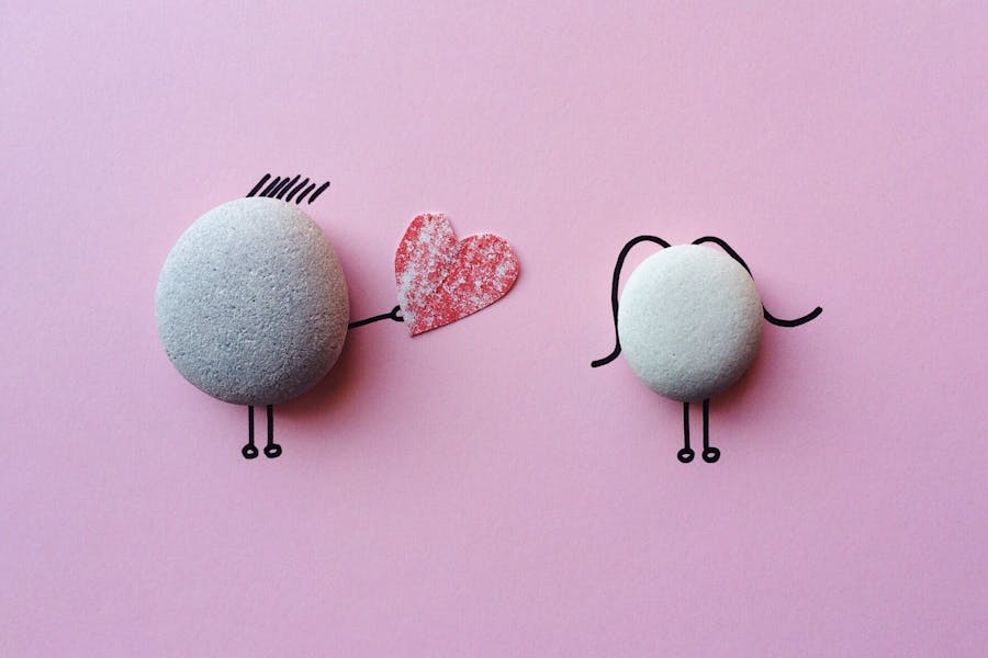 Two rocks dressed like a man and women and a red heart
