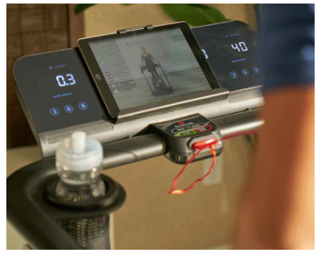 A man watching a training sessionon his indoor treadmill