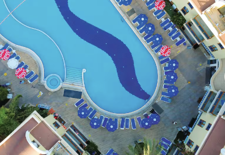 An outdoor pool with longers across for your relaxation