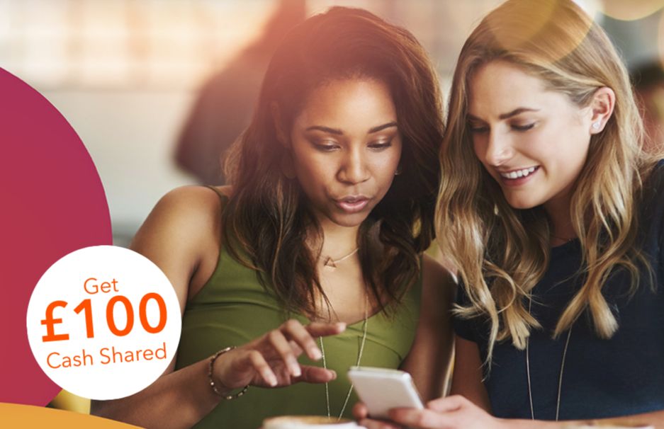 two friends look at the refer a friend program on a mobile device