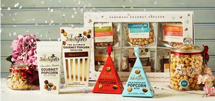 gourmet popcorn gift boxes and assorted flavoured popcorn displayed on a table