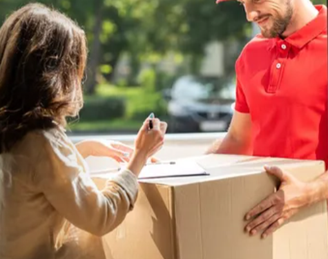 A woman signing for parcel