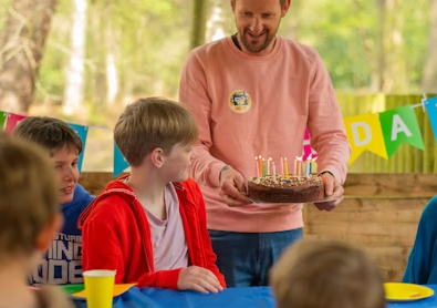 Dad giving his son a birthday cake
