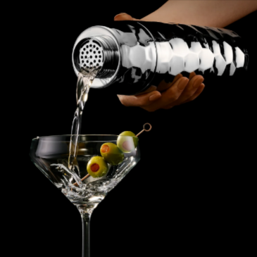 A person making a martini with a Chrome HEXCLAD cocktail shaker