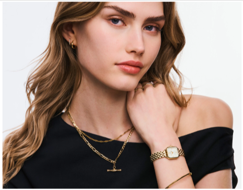 A woman wearing jewellery that she saved on with a H.Samuel voucher code from Love Discount Vouchers